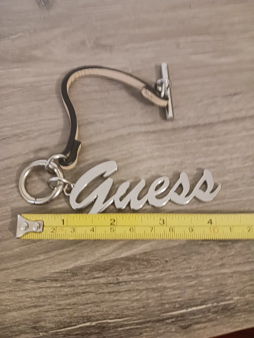 Guess Silver Script Logo Purse Charm with Toggle Leather Strap
